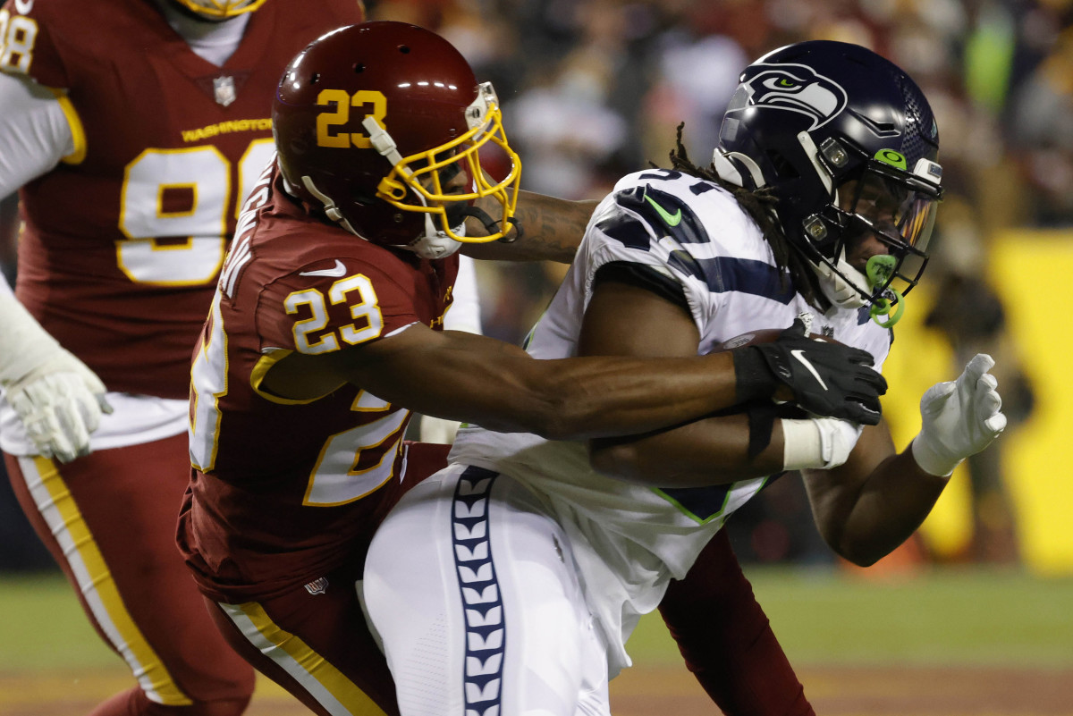 Washington Football Team cornerback William Jackson III (23) tackles Seattle Seahawks running back DeeJay Dallas (31) at FedExField.